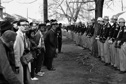 FILE - In this March 13, 1965 file photo, a line of police officers hold back demonstrators who attempted to march to the courthouse in Selma, Ala. Police kept the demonstrators hemmed up in a square block area where they attempted several times to break through. (AP Photo/File)