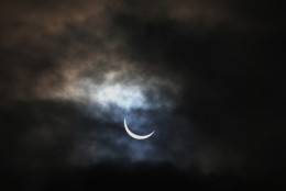 A view of the partial solar eclipse above the Angel of the North in Gateshead, England, Friday, March, 20, 2015. An eclipse is darkening parts of Europe on Friday in a rare solar event that won't be repeated for more than a decade. (AP Photo/Scott Heppell)