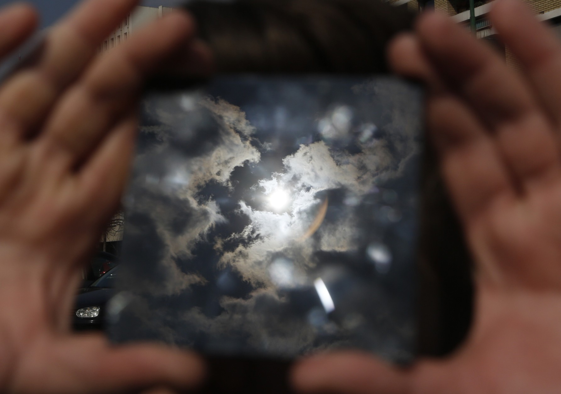 A solar eclipse is seen through a dark glass plate in Sarajevo, Bosnia , on Friday , March 20, 2015. Solar eclipse is darkening parts of Europe on Friday in a rare solar event that won't be repeated for more than a decade.(AP Photo/Amel Emric)