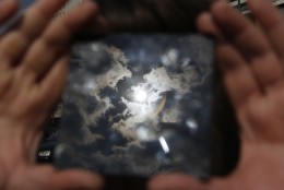 A solar eclipse is seen through a dark glass plate in Sarajevo, Bosnia , on Friday , March 20, 2015. Solar eclipse is darkening parts of Europe on Friday in a rare solar event that won't be repeated for more than a decade.(AP Photo/Amel Emric)