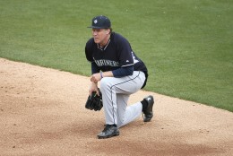 Actor Will Ferrell takes a knee while playing second base for the Seattle Mariners during the second inning of a spring training baseball game against the Oakland A's, Thursday, March 12, 2015, in Mesa, Ariz. Ferrell is filming a new special from Funny Or Die, in partnership with Major League Baseball, to air exclusively on HBO later this year. (AP Photo/Matt York)