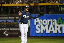 Actor Will Ferrell responds to the crowd's cheers while playing right field for the San Diego Padres during a spring training baseball game between the Padres and the Los Angeles Dodgers Thursday, March 12, 2015, in Peoria, Ariz.  (AP Photo/Lenny Ignelzi)