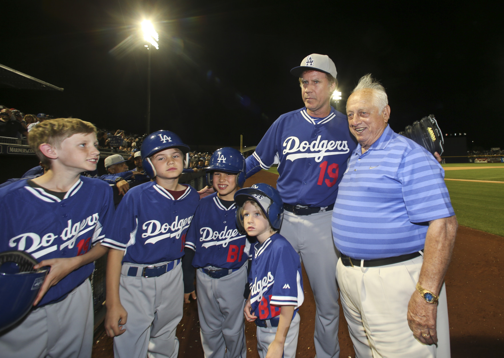 Actor Will Ferrellposes with former Los Angeles Dodgers manager Tommy Lasorda and bat boys  during a spring training baseball game between the San Diego Padres and the Los Angeles Dodgers Thursday, March 12, 2015, in Peoria, Ariz.  (AP Photo/Lenny Ignelzi)