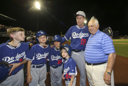 Actor Will Ferrellposes with former Los Angeles Dodgers manager Tommy Lasorda and bat boys  during a spring training baseball game between the San Diego Padres and the Los Angeles Dodgers Thursday, March 12, 2015, in Peoria, Ariz.  (AP Photo/Lenny Ignelzi)