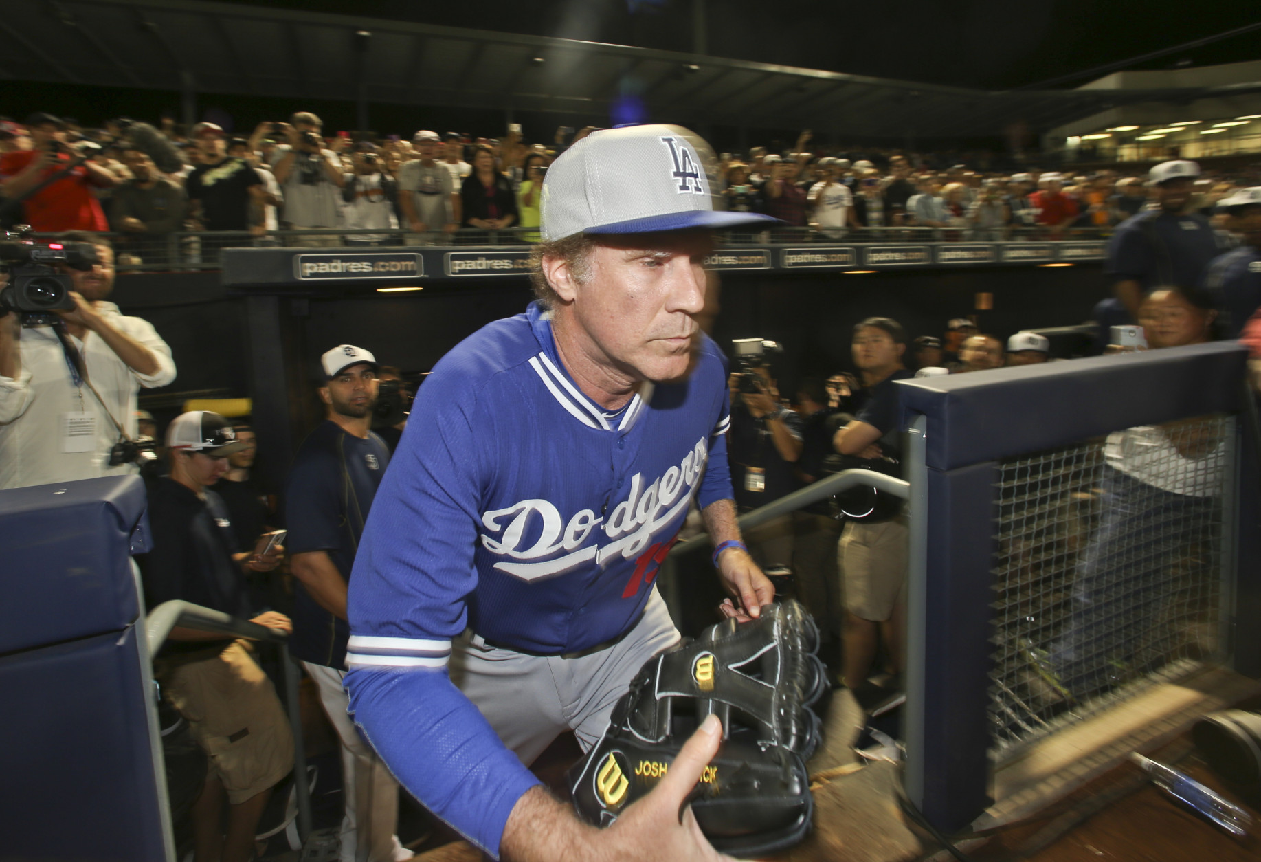 Actor Will Ferrell exits the dugout wearing a Los Angeles Dodgers uniform as he comes in to pitch in a spring training baseball game between the Dodgers and the San Diego Padres on Thursday, March 12, 2015, in Peoria, Ariz.  (AP Photo/Lenny Ignelzi)