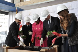 At the hotel's topping off event on Thursday, owner/developer Jacques Cohen, Managing Director Johnny So, D.C. Mayor Muriel Bowser, D.C. Councilmember Jack Evans and owner/developer Rakel Cohen plant seeds that will be used for the hotel's landscaping. (WTOP/Rachel Nania) 