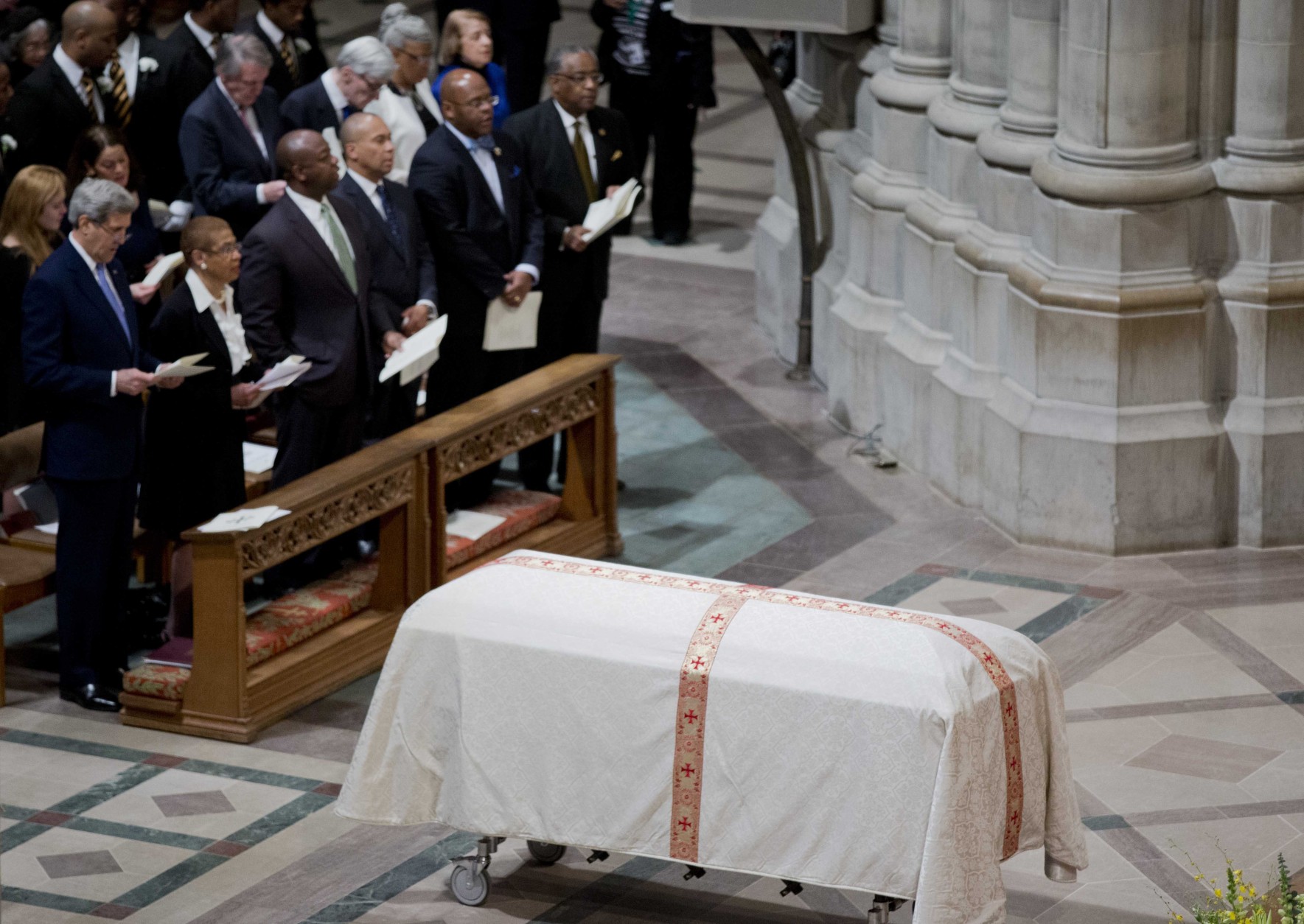 The coffin containing the remains of the late Massachusetts Sen. Edward William Brooke III, rests inside the Washington National Cathedral, in Washington, Tuesday, March 10, 2015, during a funeral services. Brooke, the first African-American to be popularly elected to the United States Senate. Brooke died on Jan. 3, 2015 at his home in Coral Gables, Fla. He was 95. Front row, from left are, Secretary of State John Kerry, Del. Eleanor Holmes Norton, D-D.C., Sen. Tim Scott, R-S.C., and former Massachusetts Gov. Deval Patrick.    (AP Photo/Manuel Balce Ceneta)