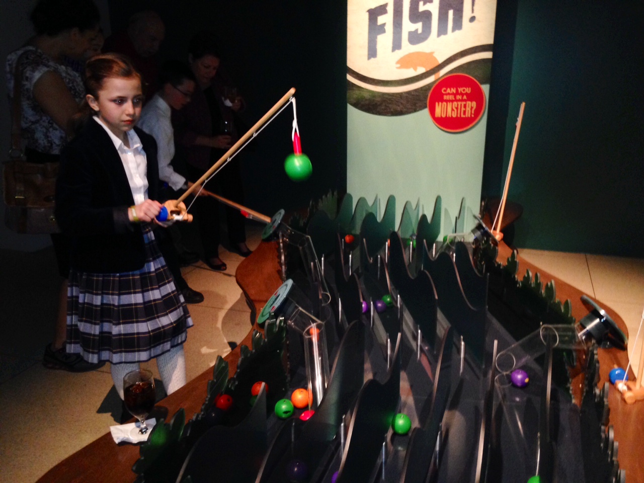 A child fishes at one of the many interactive stops within the exhibit. (WTOP/Megan Cloherty)