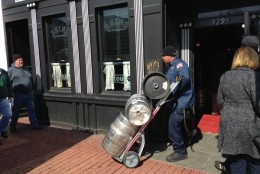 The last batch of empty kegs being wheeled out of Rhino Bar in Georgetown. (WTOP/Michelle Basch)