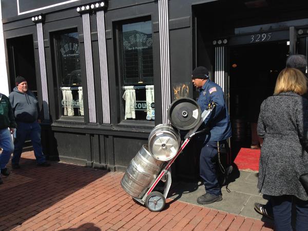 The last batch of empty kegs being wheeled out of Rhino Bar in Georgetown. (WTOP/Michelle Basch)