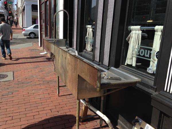 A big sink is now sitting on M Street in front of Rhino Bar, which closed Saturday . (WTOP/Michelle Basch)
