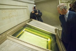 Britain's Prince Charles looks at the Declaration of Independence during a visit to the National Archives in Washington, Wednesday, March 18, 2015. Prince Charles and his wife Camilla, the Duchess of Cornwall, are scheduled to visit cultural and educational sites over the next three days. (AP Photo/ Evan Vucci)