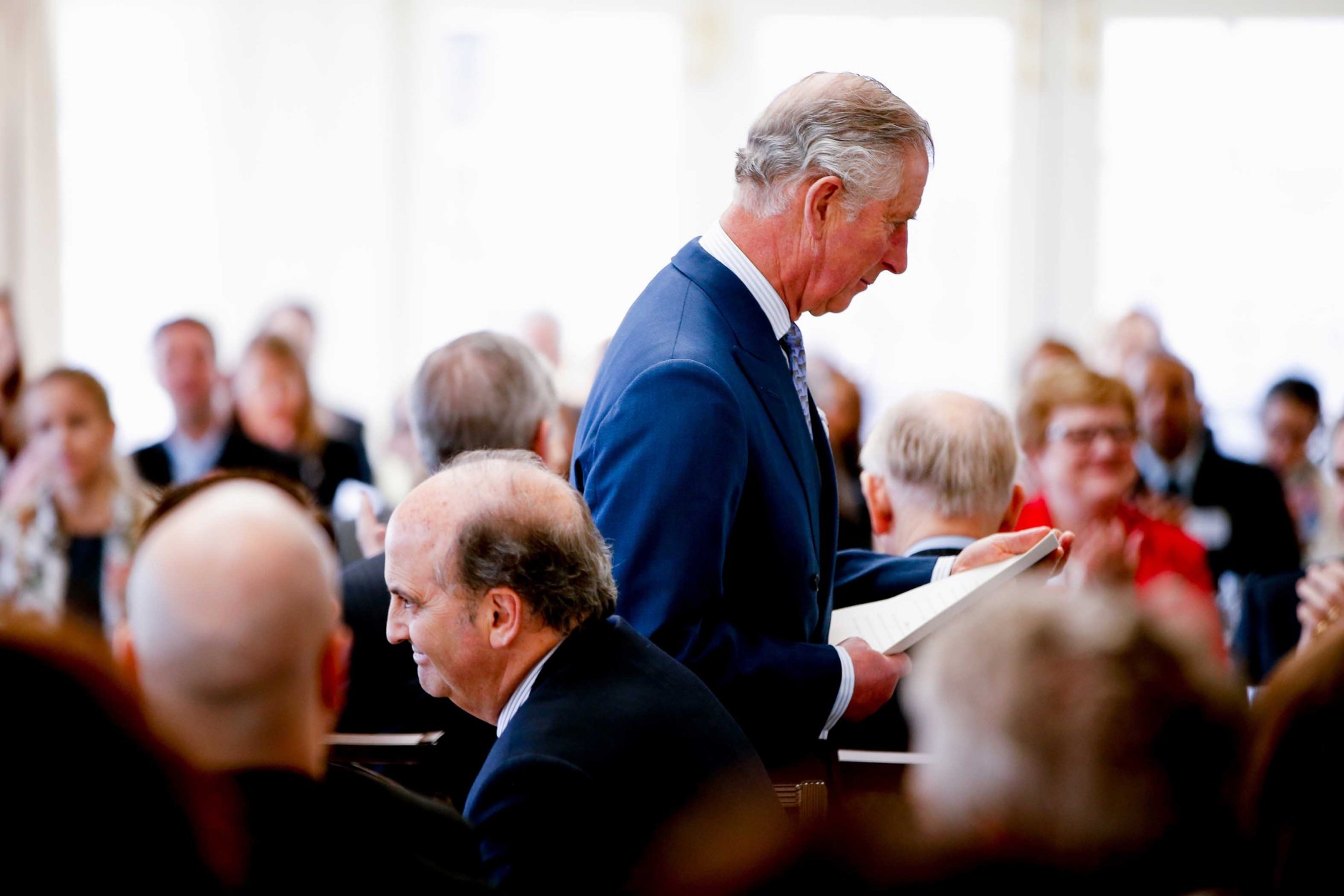 Britain’s Prince Charles returns to his seat after speaking at a meeting of companies, leading environmental organizations and government figures brought together to consider actions to address the threat posed by marine plastic waste, Wednesday, March 18, 2015, at the Hay Adams Hotel in Washington. (AP Photo/Andrew Harnik)