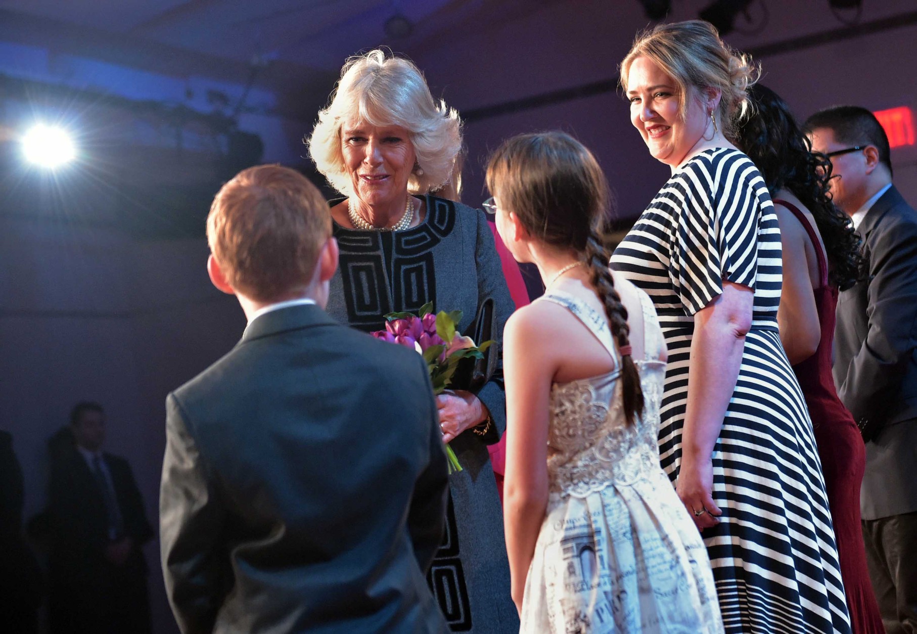 Camilla, the Duchess of Cornwall, greets young performers during a visit to the Shakespeare Theatre Company at Sidney Harman Hall  on March 18, 2015 in Washington. (AP Photo/Mandel Ngan, Pool)