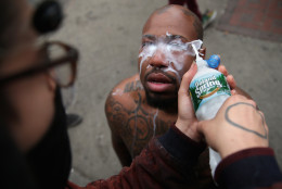 A man has his eyes cleaned after he was pepper sprayed by the Baltimore Police at the corner of Pennsylvania and North avenues during violent protests following the funeral of Freddie Gray April 27, 2015 in Baltimore, Maryland. Gray, 25, who was arrested for possessing a switch blade knife April 12 outside the Gilmor Homes housing project on Baltimore's west side. According to his attorney, Gray died a week later in the hospital from a severe spinal cord injury he received while in police custody.  (Photo by Chip Somodevilla/Getty Images)