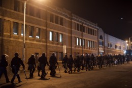 Riot police depart after forming a barricade and dispensing tear gas near the burned out CVS pharmacy the night after citywide riots over the death of Freddie Gray on April 28, 2015 in Baltimore, Maryland. Freddie Gray, 25, was arrested for possessing a switch blade knife April 12 outside the Gilmor Houses housing project on Baltimore's west side. According to his attorney, Gray died a week later in the hospital from a severe spinal cord injury he received while in police custody. (Photo by Mark Makela/Getty Images)