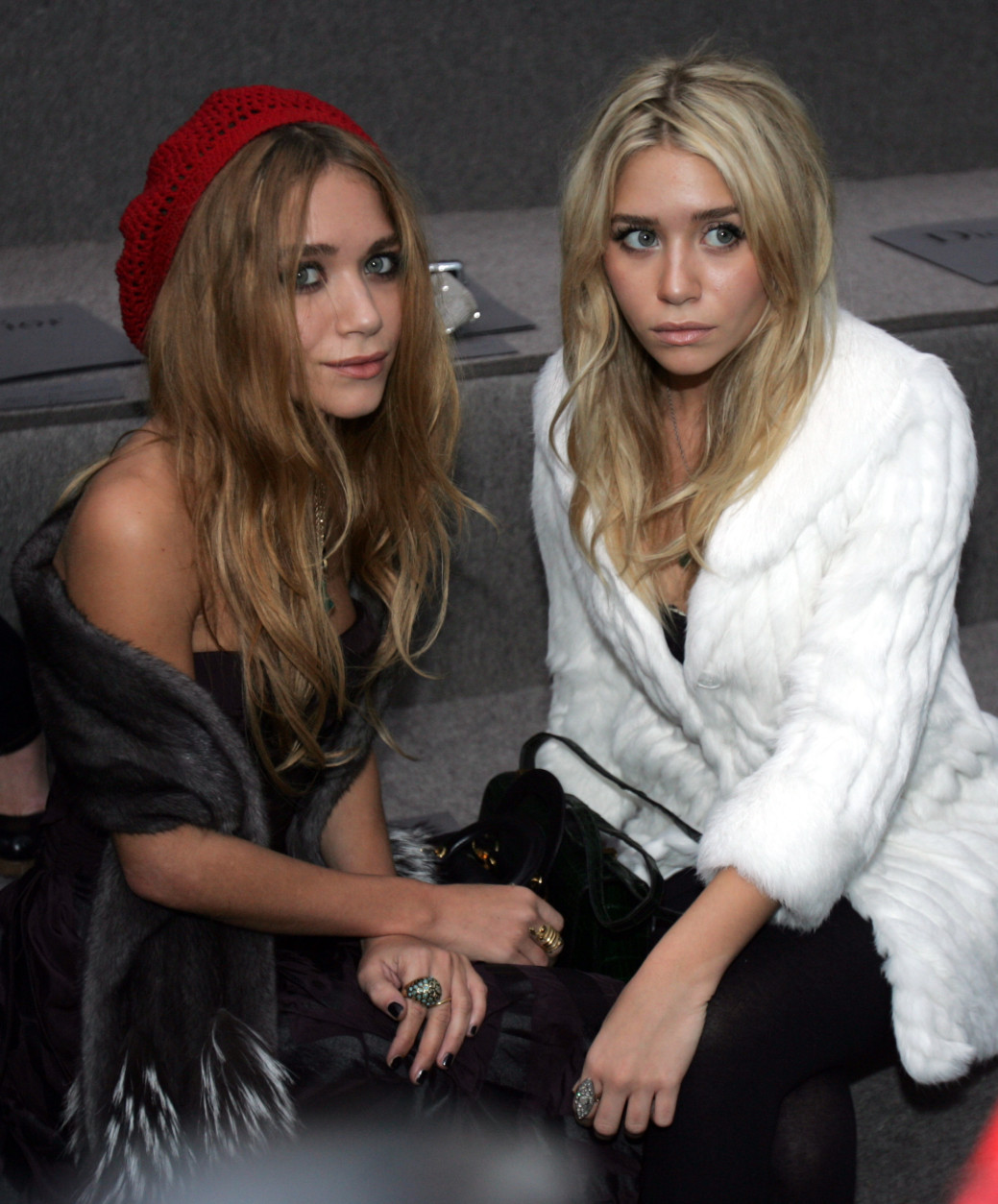 ** FILE ** Twin actresses Mary-Kate, left, and Ashley Olsen pose for the press prior to the  presentation of the Spring-Summer 2007 ready to wear collection by British designer John Galliano for French fashion house Dior in Paris, in this Oct. 3, 2006 file photo. The Olsen twins are hoping to spread a little "Influence."  Mark Kate-Olsen and Ashley Olsen are working on a coffee table book about fashion, called "Influence," that a division of Penguin Group (USA) will release in the fall. (AP Photo/Remy de la Mauviniere, File)