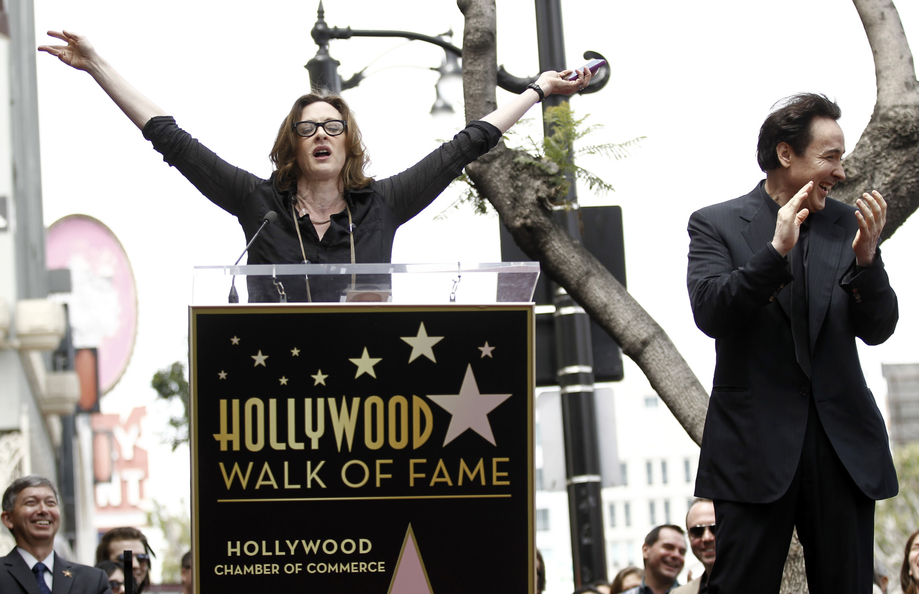 Actress Joan Cusack, left, speaks before her brother John Cusack received a star on the Hollywood Walk of Fame in Los Angeles, Tuesday, April 24, 2012. Cusack stars in "The Raven" which opens in theaters April 27. (AP Photo/Matt Sayles)