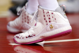 Washington Wizards guard John Wall (2) wears newly designed cherry blossom inspired shoes by Adidas in the first half of an NBA basketball game against the Portland Trail Blazers, Monday, March 16, 2015, in Washington. (AP Photo/Alex Brandon)