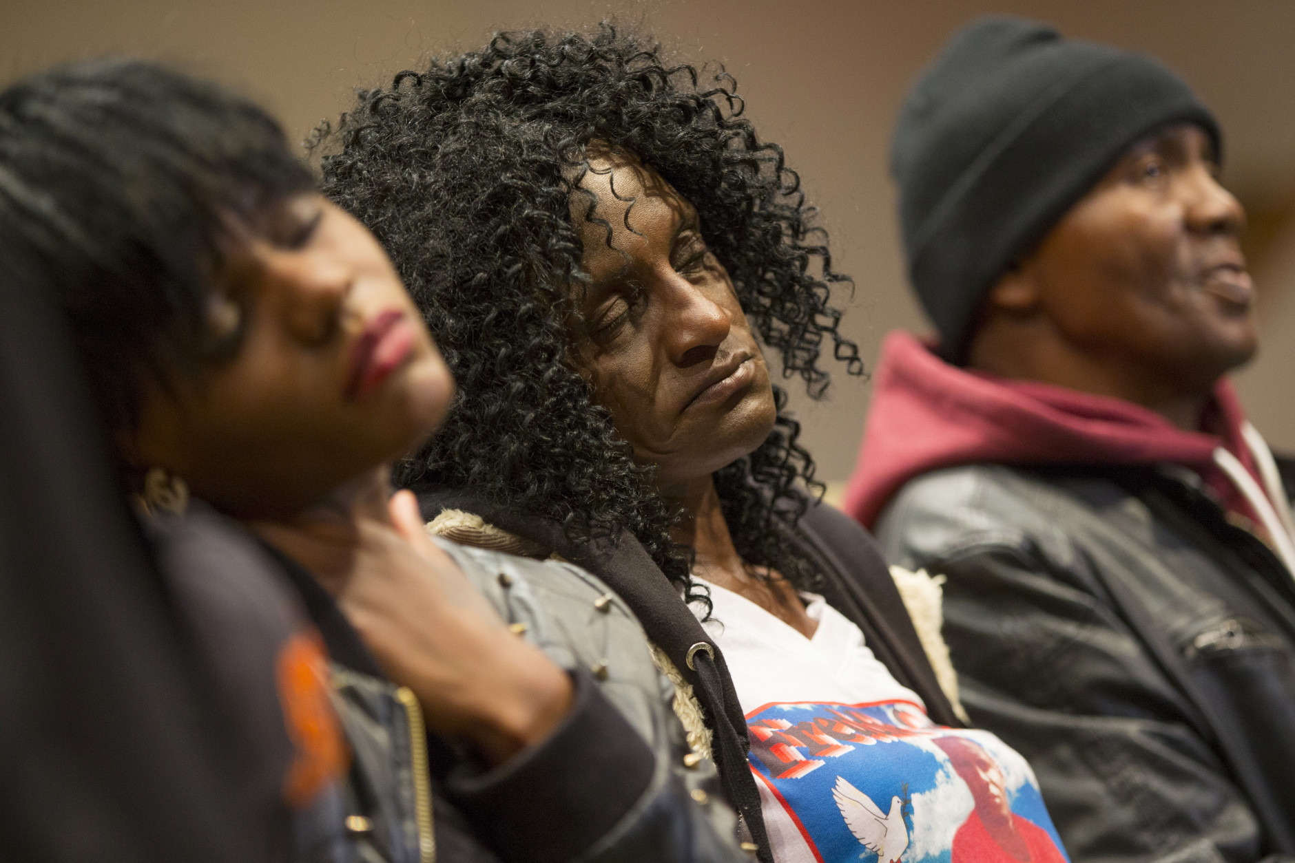 Family members of Freddie Gray, sister Fredricka Gray, left, mother Gloria Darden, center, and stepfather Richard Shipley listen during a news conference after a day of unrest following the funeral of Freddie Gray on Monday, April 27, 2015, in Baltimore. Rioters plunged part of Baltimore into chaos torching a pharmacy, setting police cars ablaze and throwing bricks at officers. (AP Photo/Evan Vucci)