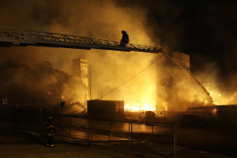 Firefighters battle a blaze, Monday, April 27, 2015, after rioters plunged part of Baltimore into chaos, torching a pharmacy, setting police cars ablaze and throwing bricks at officers.  (AP Photo/Patrick Semansky)