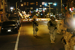 Members of the National Guard walk along North Avenue near where Monday's riots occurred following the funeral for Freddie Gray, after a 10 p.m. curfew went into effect Wednesday, April 29, 2015, in Baltimore. (AP Photo/David Goldman)