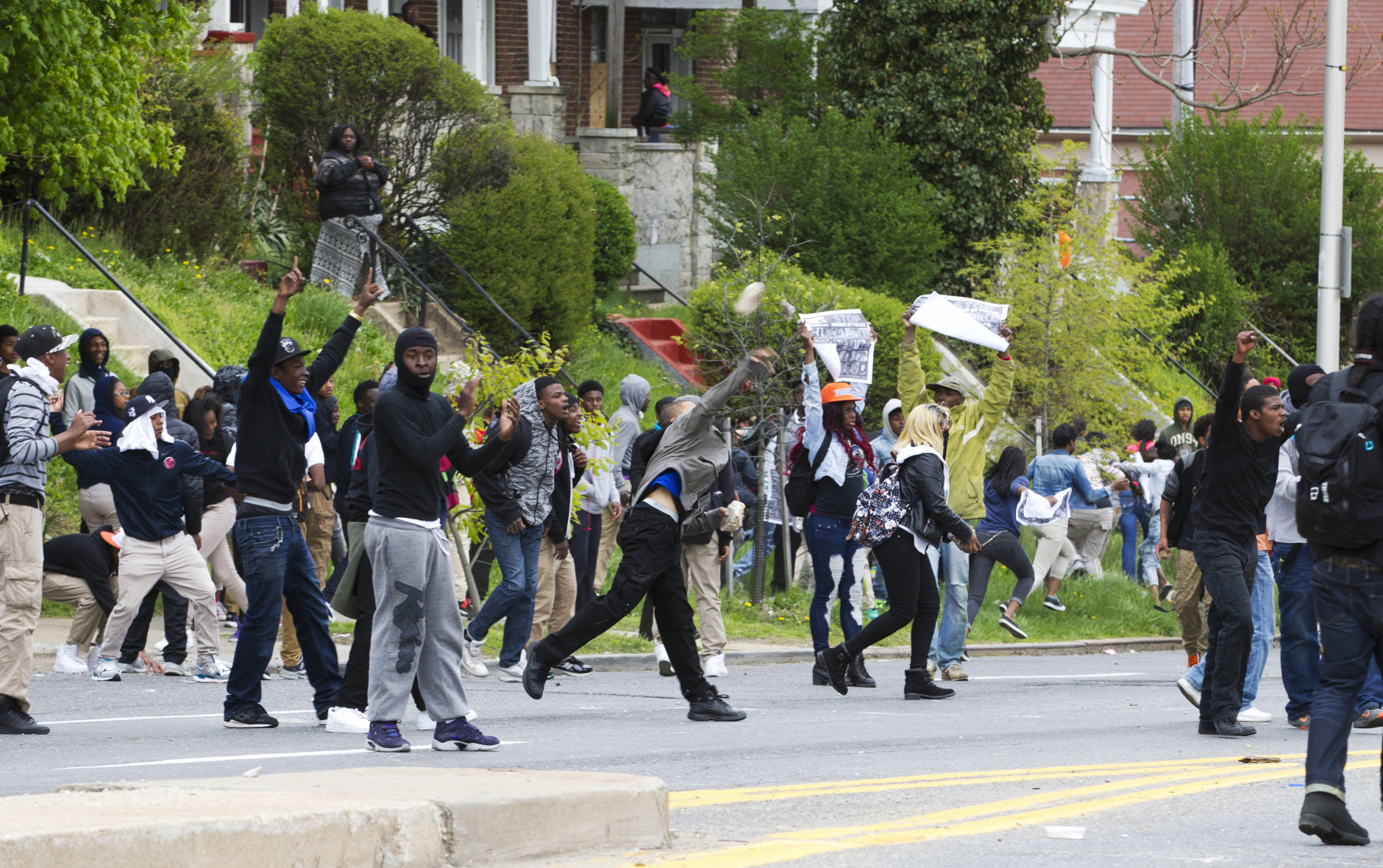 Demonstrators throw rocks to the police, after the funeral of Freddie Gray, Monday, April 27, 2015, at New Shiloh Baptist Church in Baltimore. Gray died from spinal injuries about a week after he was arrested and transported in a Baltimore Police Department van.  (AP Photo/Jose Luis Magana)