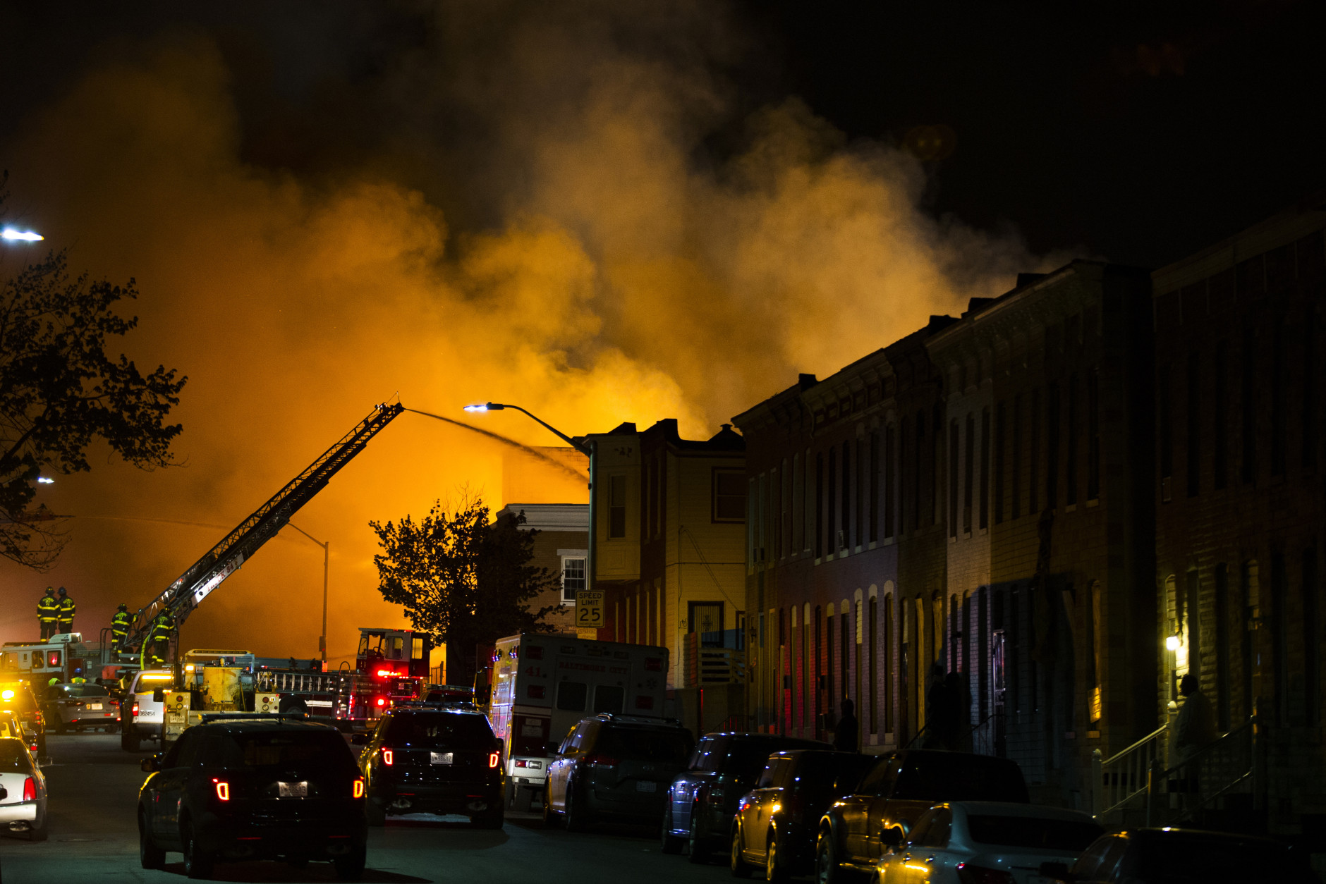 Firefighters battle a blaze, Monday, April 27, 2015, after rioters plunged part of Baltimore into chaos, torching a pharmacy, setting police cars ablaze and throwing bricks at officers. (AP Photo/Evan Vucci)