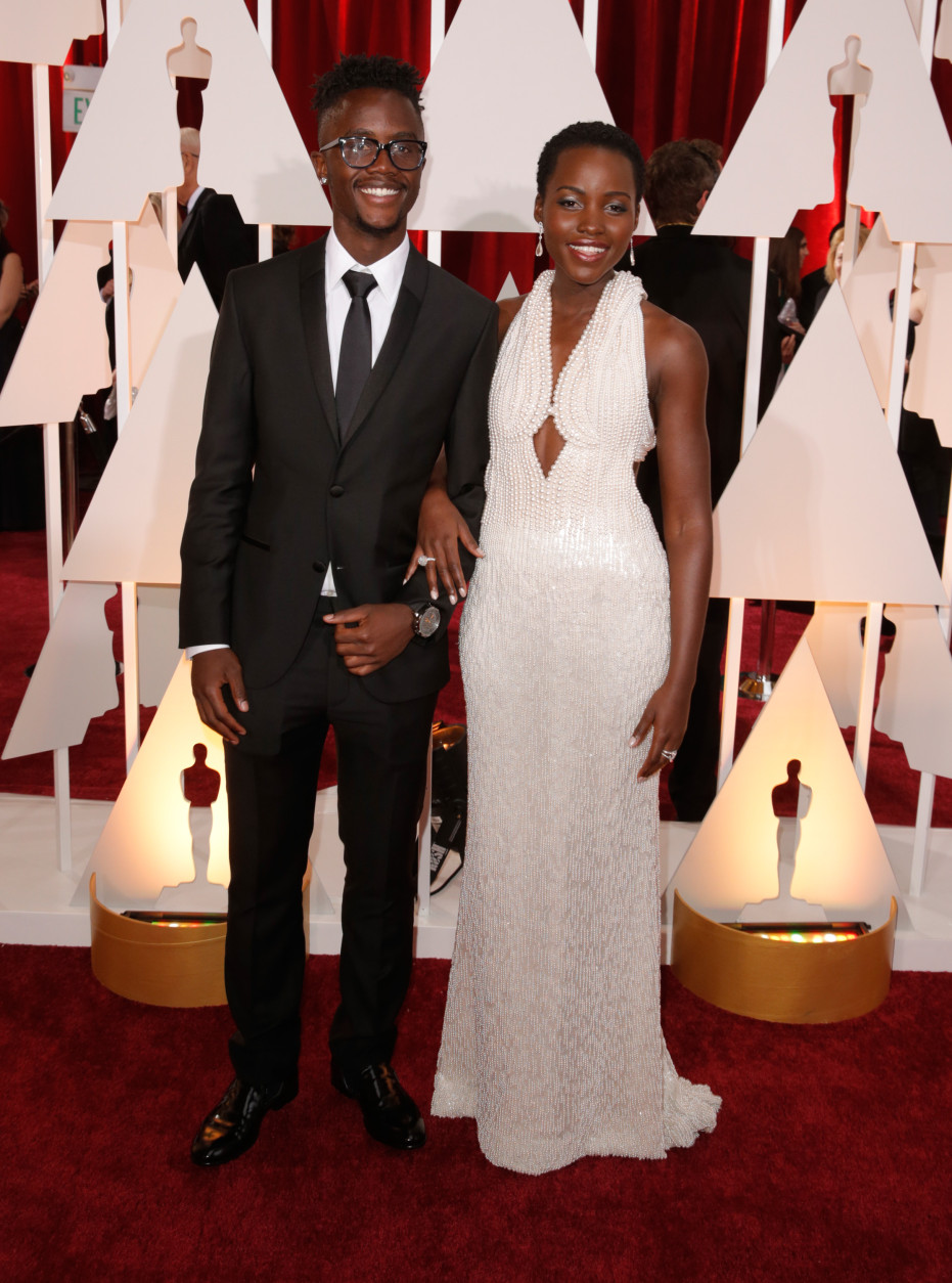 Peter Nyong'o, left, and Lupita Nyong'o arrive at the Oscars on Sunday, Feb. 22, 2015, at the Dolby Theatre in Los Angeles. (Photo by Todd Williamson/Invision/AP)