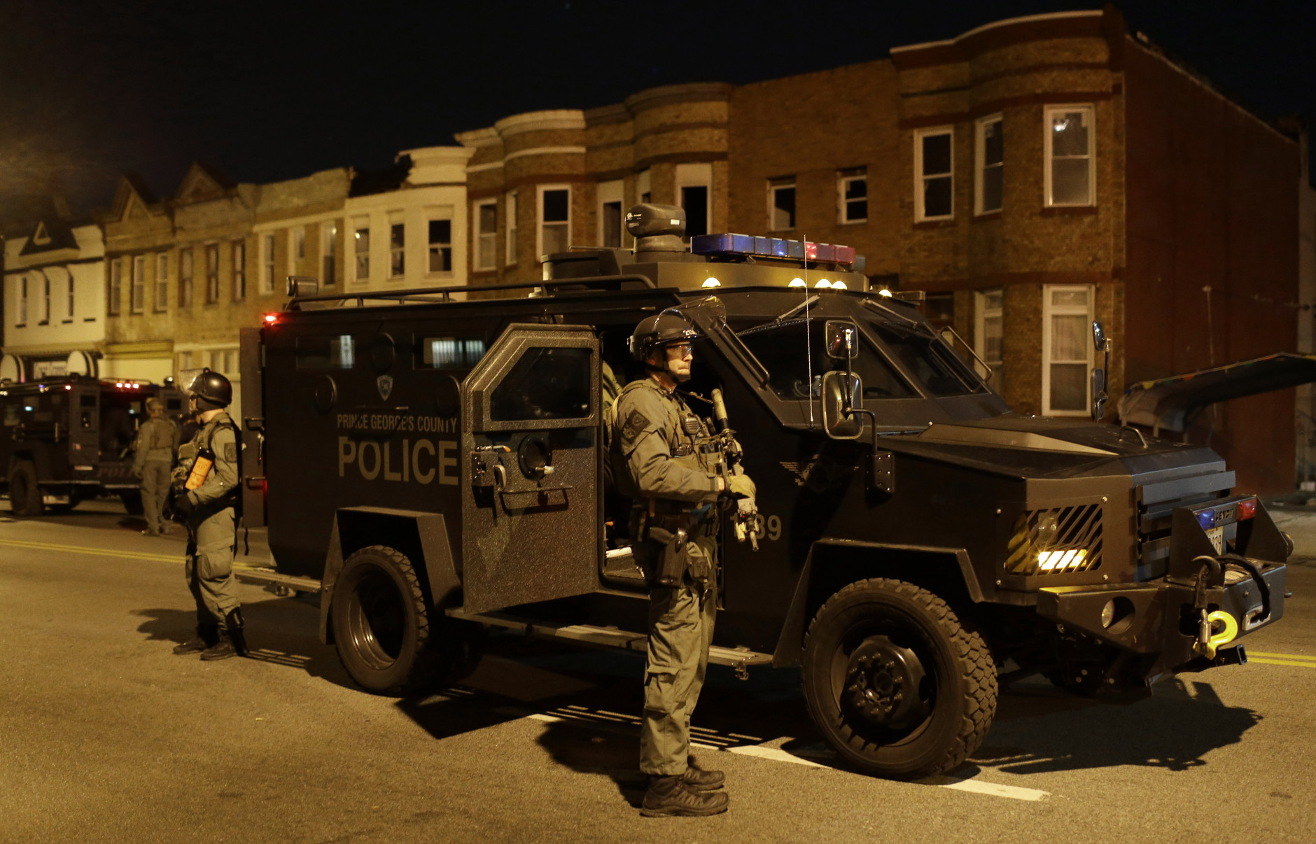 Prince George's County Police enforce curfew, Tuesday, April 28, 2015, in Baltimore, a day after unrest that occurred following Freddie Gray's funeral. (AP Photo/Patrick Semansky)