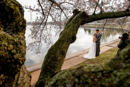 With the Washington Monument in the background, left, Rebekah Murray of Leesburg, Va., right, photographs Luke and Carolyn Woods of Silver Spring, Md., among the cherry blossoms trees along the Tidal Basin in Washington, Tuesday, April 7, 2015. Luke and Carolyn were married 4 years ago and are retaking their wedding photos. Officials are calling for a peak bloom period from April 11-14th. (AP Photo/Andrew Harnik)