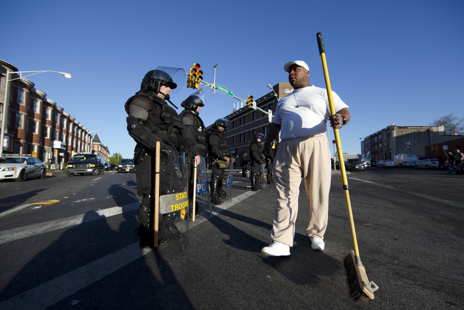 Victor Huntley-el thanks law enforcement officers as they stand guard, Tuesday, April 28, 2015, in Baltimore, in the aftermath of rioting following Monday's funeral for Freddie Gray, who died in police custody. (AP Photo/Matt Rourke)