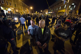 U.S. Rep. Elijah Cummings, D-Md., asks people to go home after the 10 p.m. curfew Tuesday, April 28, 2015, in Baltimore. A line of police behind riot shields hurled smoke grenades and fired pepper balls at dozens of protesters to enforce a citywide curfew. (AP Photo/Matt Rourke)