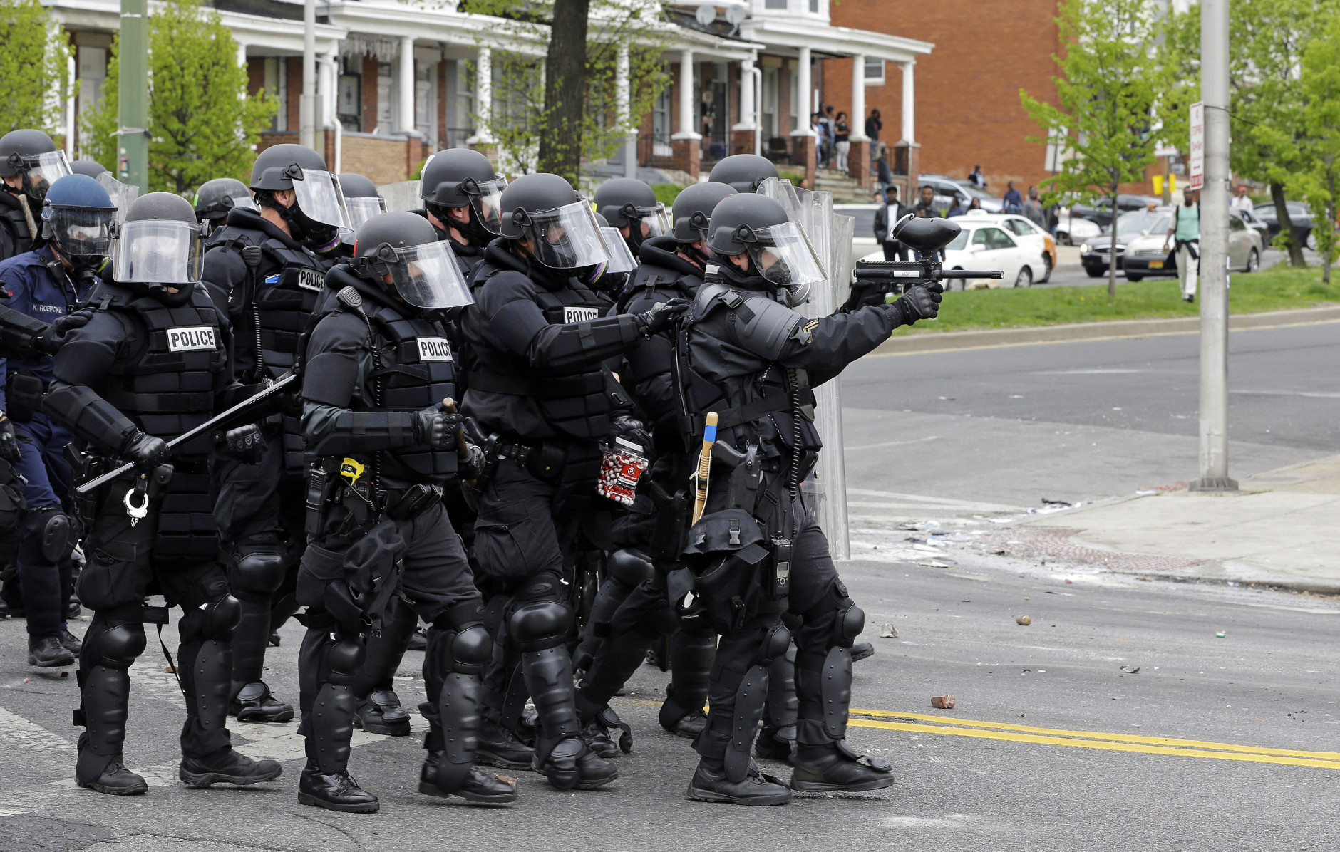 Police move down a street in response to demonstrators who were throwing objects, Monday, April 27, 2015, after the funeral of Freddie Gray in Baltimore. Gray died from spinal injuries about a week after he was arrested and transported in a Baltimore Police Department van. (AP Photo/Patrick Semansky)