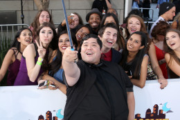 Harvey Guillen takes a selfie with fans as he arrives at the MTV Movie Awards at the Nokia Theatre on Sunday, April 12, 2015, in Los Angeles. (Photo by Matt Sayles/Invision/AP)