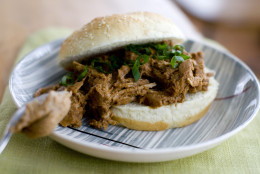 In this image taken on Nov. 28, 2011, almond butter gives a thick, rich texture and flavor to this mole-style pulled pork sandwich shown served on a plate in Concord, N.H. (AP Photo/Matthew Mead)