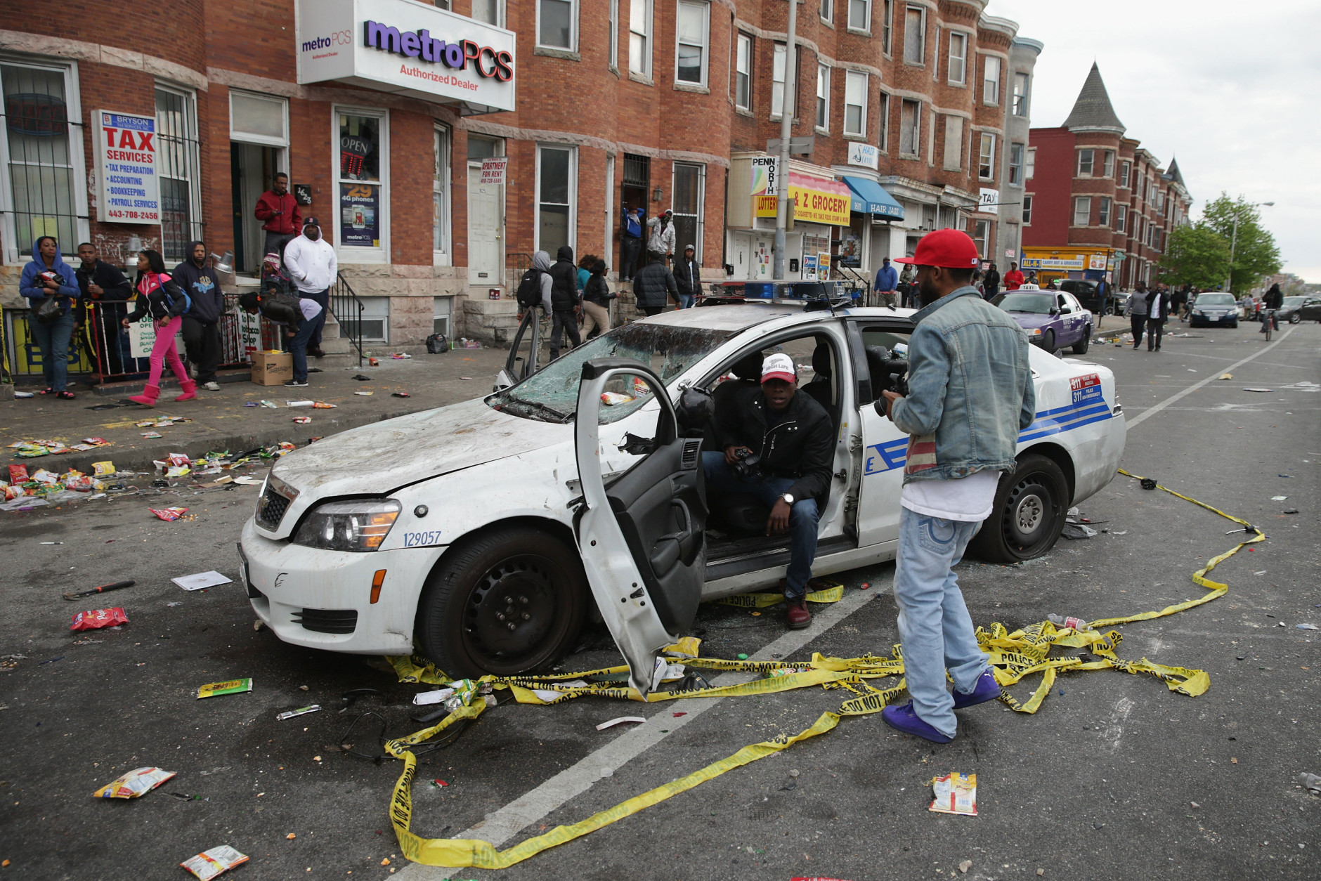 BALTIMORE, MD - APRIL 27: A Baltimore Police car destroyed by demonstrators sits in the street near the corner of Pennsylvania and North avenues during violent protests following the funeral of Freddie Gray April 27, 2015 in Baltimore, Maryland. Gray, 25, who was arrested for possessing a switch blade knife April 12 outside the Gilmor Homes housing project on Baltimore's west side. According to his attorney, Gray died a week later in the hospital from a severe spinal cord injury he received while in police custody. (Photo by Chip Somodevilla/Getty Images)