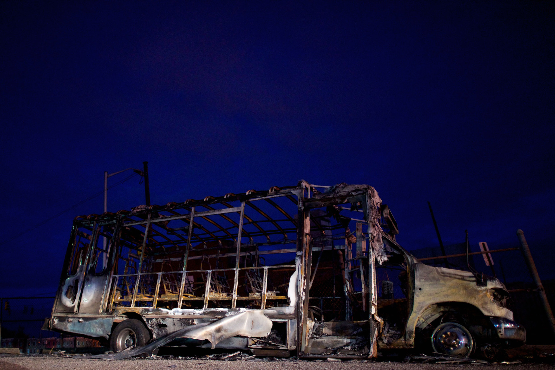 BALTIMORE, MD - APRIL 28: The remains of a senior center bus set ablaze during night riots are seen at dawn on April 28, 2015 in Baltimore, Maryland. Freddie Gray, 25, was arrested for possessing a switch blade knife April 12 outside the Gilmor Houses housing project on Baltimore's west side. According to his attorney, Gray died a week later in the hospital from a severe spinal cord injury he received while in police custody. (Photo by Mark Makela/Getty Images)