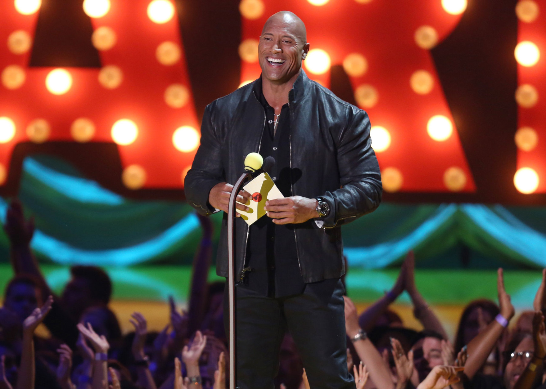 Dwayne Johnson presents the award for movie of the year at the MTV Movie Awards at the Nokia Theatre on Sunday, April 12, 2015, in Los Angeles. (Photo by Matt Sayles/Invision/AP)