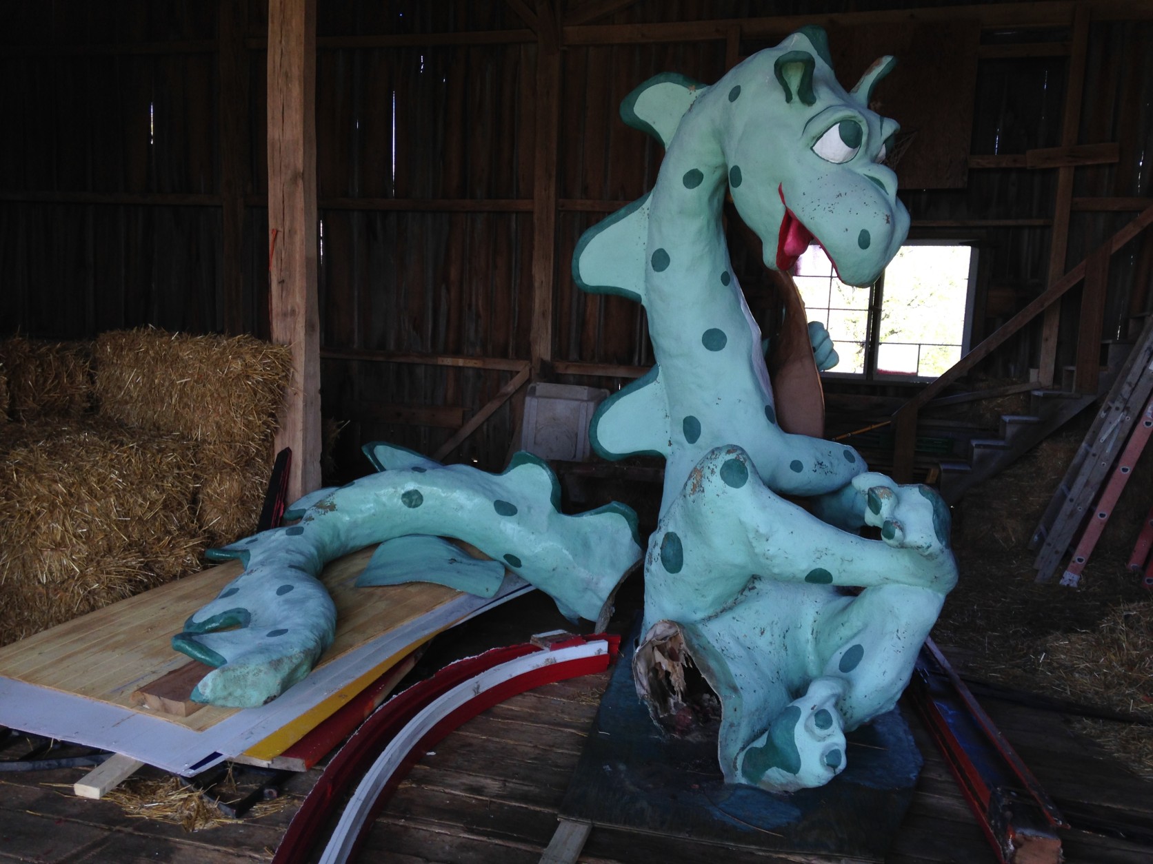 The friendly-looking dragon from the theme park's entrance was recently moved to a barn at nearby Clark's Elioak Farm. The dragon will be repaired and repainted for future display. (WTOP/Michelle Basch)