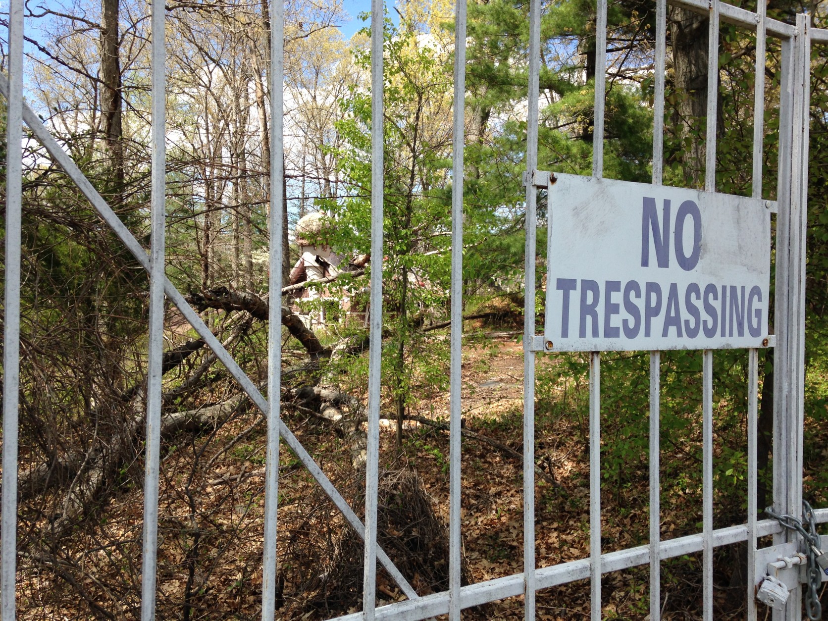 Behind the Enchanted Forest shopping center and a locked gate, you can still spot two abandoned theme park buildings through the trees. (WTOP/Michelle Basch)