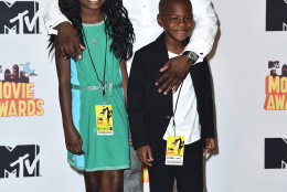 Kevin Hart, winner of the comedic genius award, poses in the press room with his kids Heaven Hart, left, and Hendrix Hart, right, at the MTV Movie Awards at the Nokia Theatre on Sunday, April 12, 2015, in Los Angeles. (Photo by Jordan Strauss/Invision/AP)