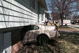 The driver is OK after the car he was driving went into this Lanham home. (PGFD)