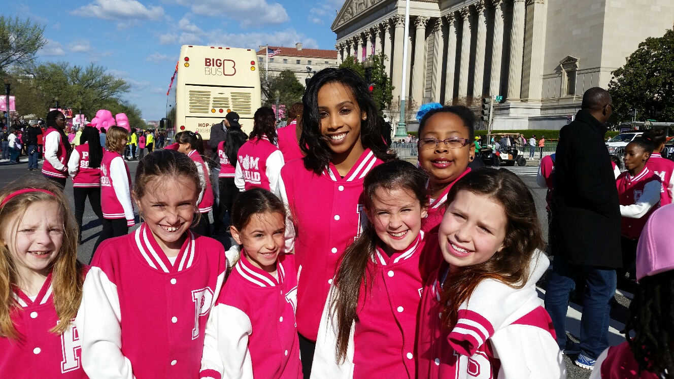 Latasha Better, a Redskins cheerleader, with the Pom Squad (Pom-Positive Outcome Mentoring). The dance team performed at the Cherry Blossom Parade on April 11, 2015. (WTOP/Kathy Stewart)