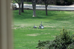 A police device rolls toward a copter device, right, that landed on the West Front of the Capitol in Washington, Wednesday, April 15, 2015. A small one-person helicopter has landed on the West Lawn of the U.S. Capitol, prompting a temporary lockdown of the Capitol Visitor's Center. Capitol Police approached the aircraft shortly after it touched down and took its pilot into custody. (AP Photo/Lauren Victoria Burke)