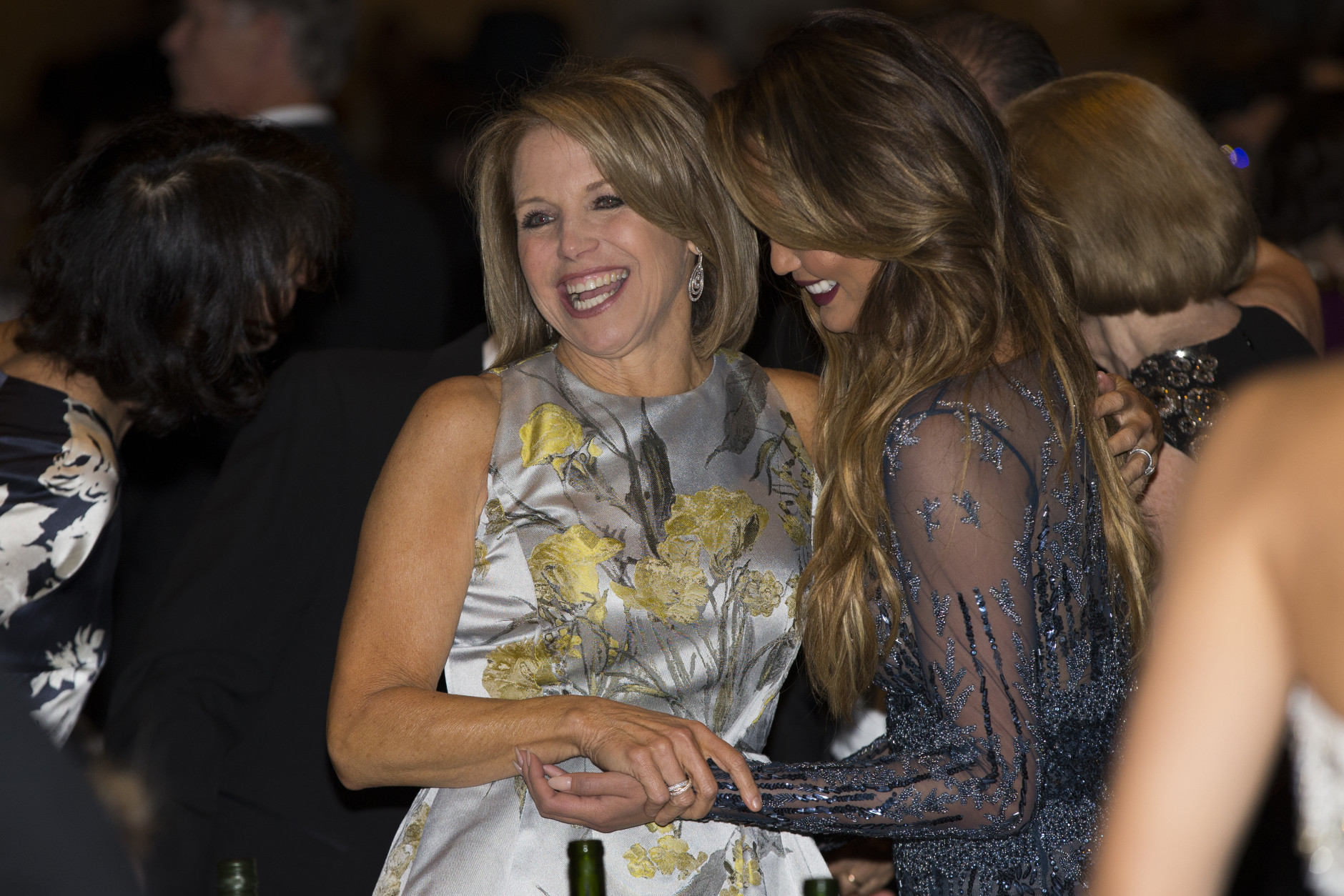 News personality Katie Couric, left, and model Chrissy Teigen mingle during the White House Correspondents' Association dinner at the Washington Hilton on Saturday, April 25, 2015, in Washington. (AP Photo/Evan Vucci)