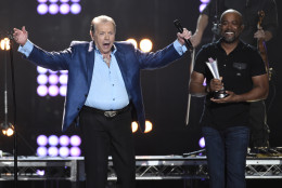 Mickey Gilley accepts the triple crown award at ACM Presents Superstar Duets at Globe Life Park on Friday, April 17, 2015, in Arlington, Texas. Looking on at right is Darius Rucker. (Photo by Chris Pizzello/Invision/AP)