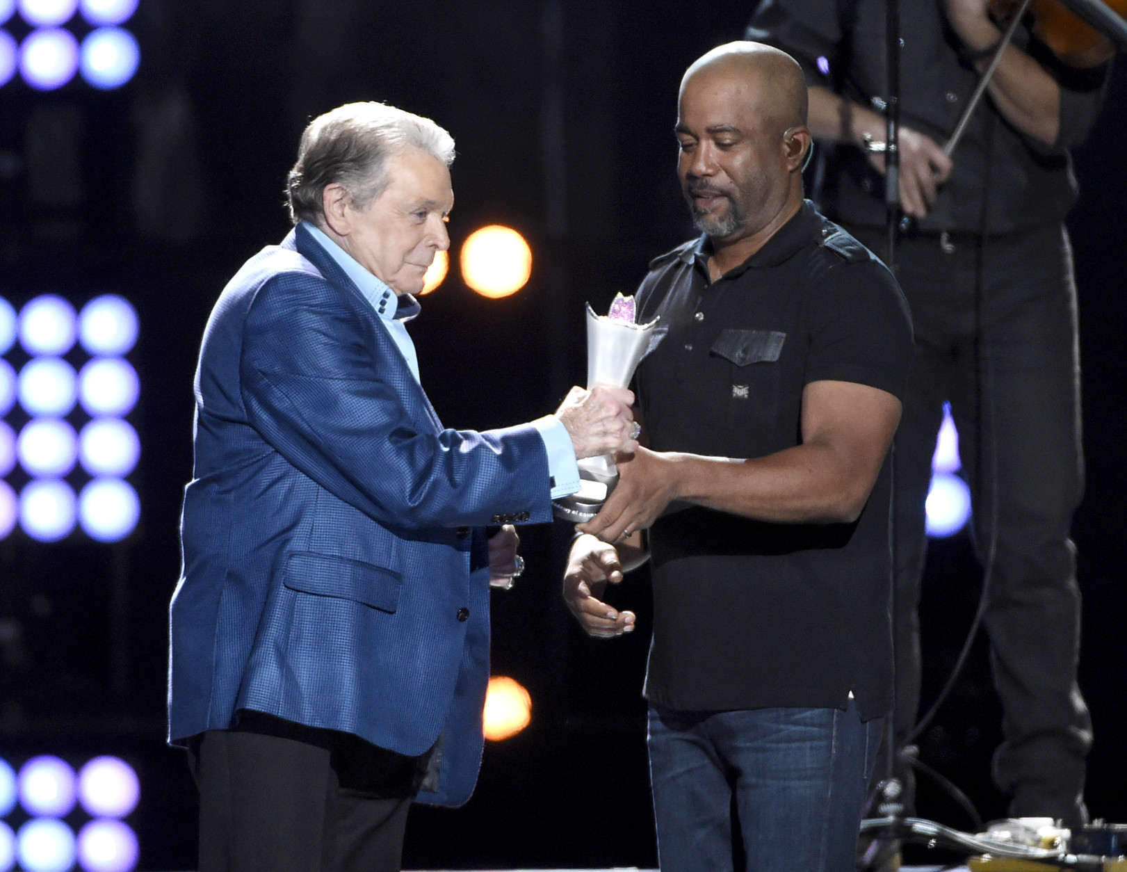 Darius Rucker, right, presents the triple crown award to Mickey Gilley at ACM Presents Superstar Duets at Globe Life Park on Friday, April 17, 2015, in Arlington, Texas. (Photo by Chris Pizzello/Invision/AP)
