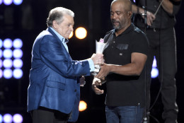 Darius Rucker, right, presents the triple crown award to Mickey Gilley at ACM Presents Superstar Duets at Globe Life Park on Friday, April 17, 2015, in Arlington, Texas. (Photo by Chris Pizzello/Invision/AP)