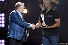 Darius Rucker, right, presents the triple crown award to Mickey Gilley at ACM Presents Superstar Duets at Globe Life Park on Friday, April 17, 2015, in Arlington, Texas. (Photo by Chris Pizzello/Invision/AP)